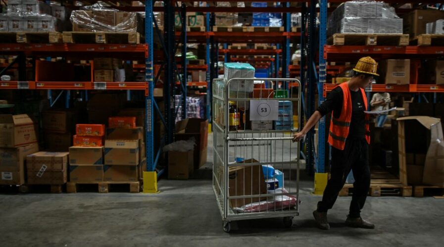 E-commerce events such as Singles' Day is hugely popular in SEA - but logistics players are struggling to keep up with consumer demand. (Photo by Hector RETAMAL / AFP)