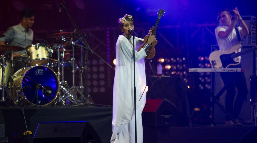 Blockchain could turn the tide for the media and entertainment industry and benefit content creators. (Pictured: Yuna performing on stage at the MTV World Stage Live in Malaysia 2014) (Photo by MOHD RASFAN / AFP)