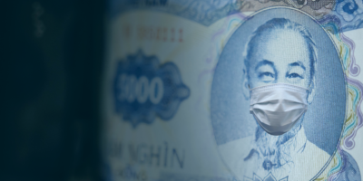 Five thousand Vietnam dong bill with a medical face mask on leader. Business concept. Selective focus.